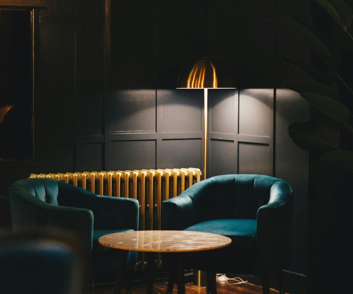 A moody luxury bar or restaurant interior designed by Atlantic Interiors - atmospheric pendant lighting and rich materials