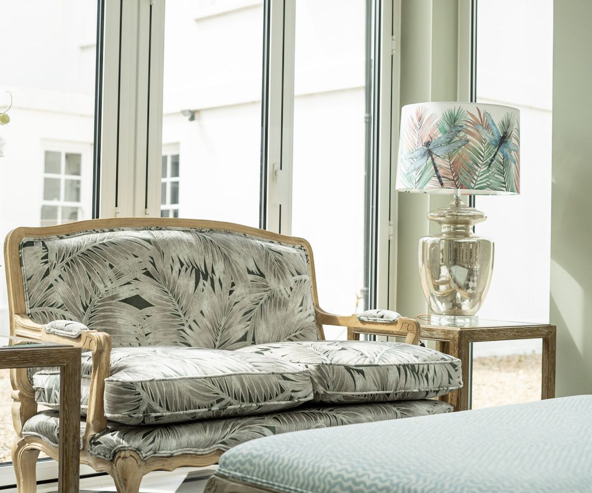 A classical interior with an ornate carved chair and botanical artwork - full-service interior design by Atlantic Interiors