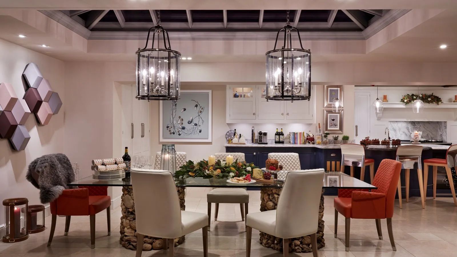 A full-width view of the open-plan kitchen orangery showing the dining area, pendant lanterns and connection to the kitchen - Atlantic Interiors, Kent