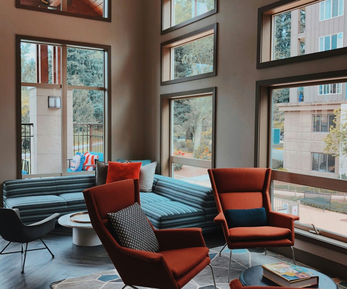 A modern commercial interior with floor-to-ceiling windows and contemporary seating — commercial design by Atlantic Interiors
