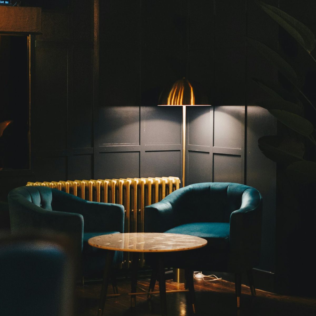 A moody luxury bar or restaurant interior designed by Atlantic Interiors - atmospheric pendant lighting and rich materials