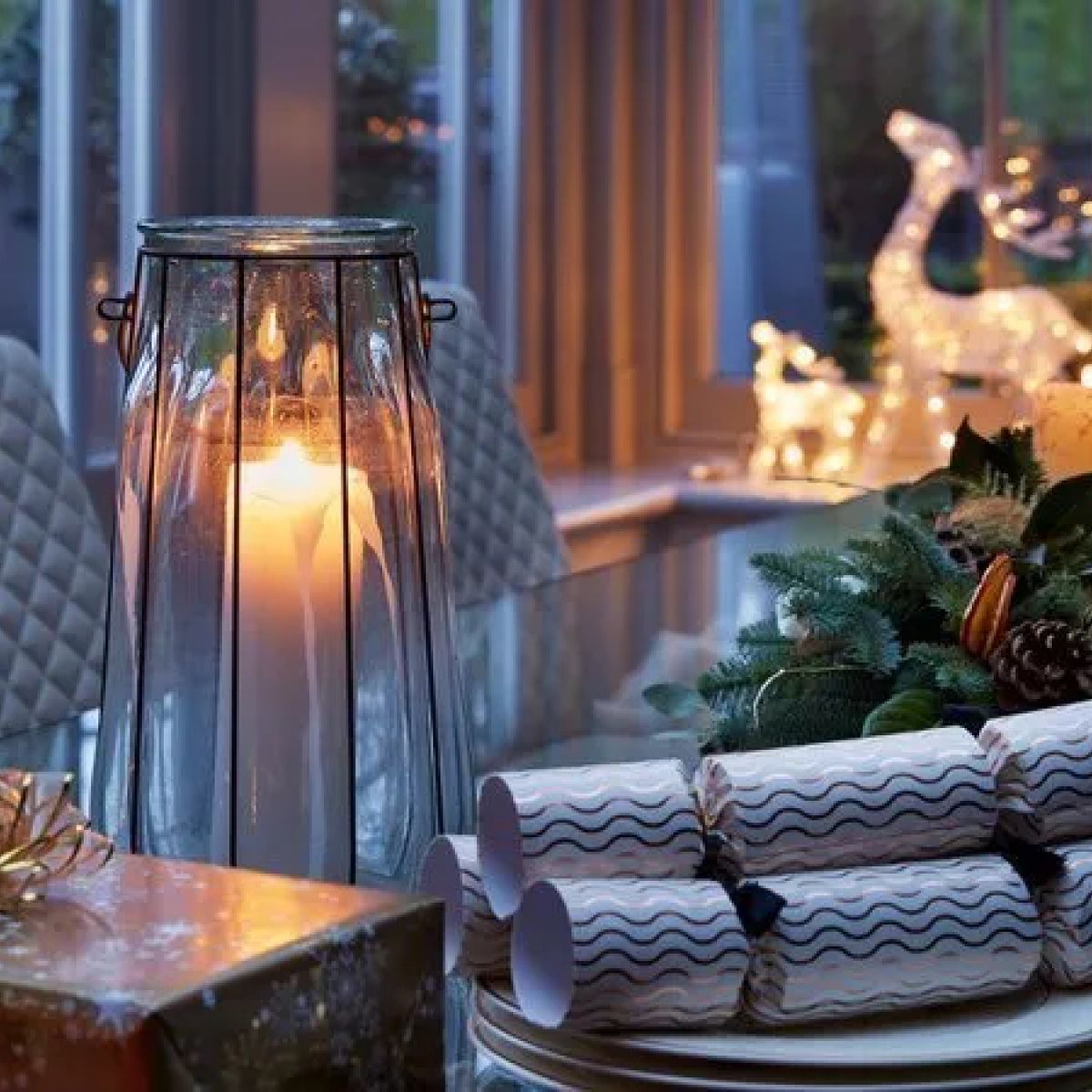 A festive Christmas table detail within the Kitchen Orangery - decorative reindeer, candles and seasonal styling, Kent