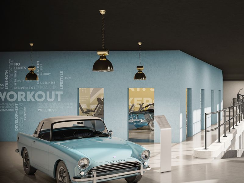 A gym and workout space within Len House, Maidstone featuring a vintage car display and artwork - amenity spaces designed around the building's history